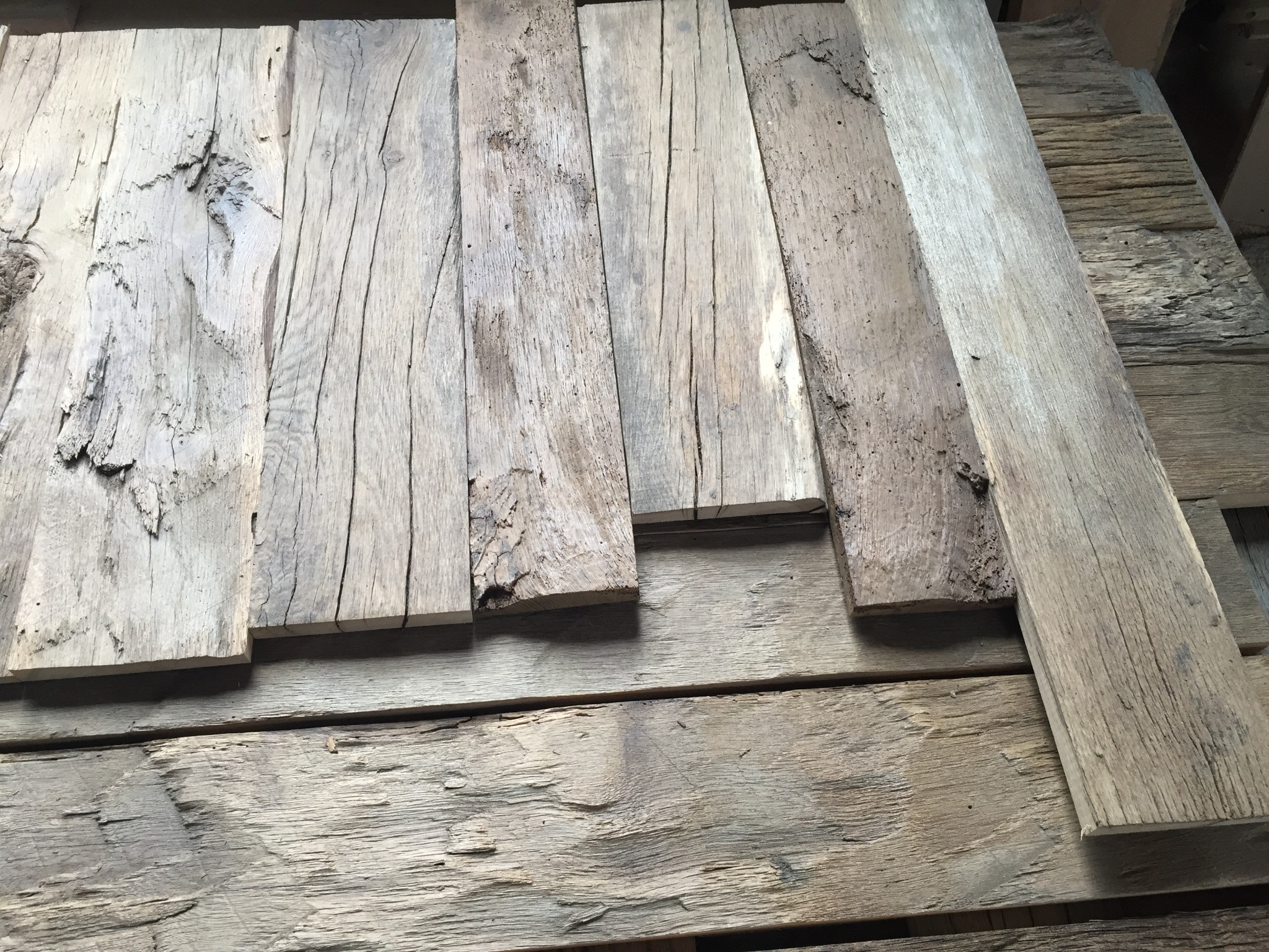 Selection of reclaimed oak boards and planks prepared for matching and further processing