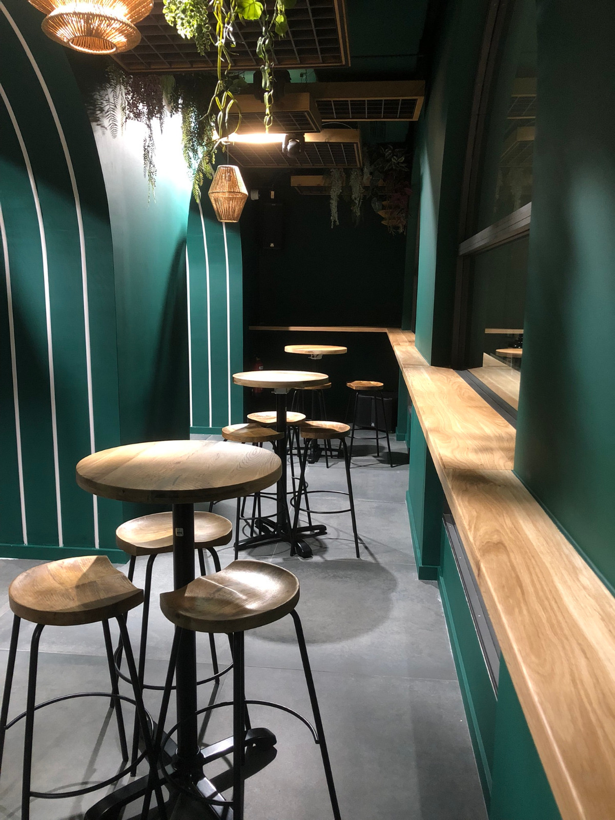Restaurant interior with solid wood bar tables and metal stools, European restaurant furniture