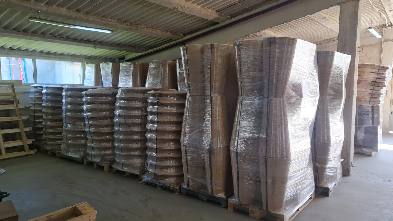 Custom solid wood furniture bases packaged on pallets, prepared for export